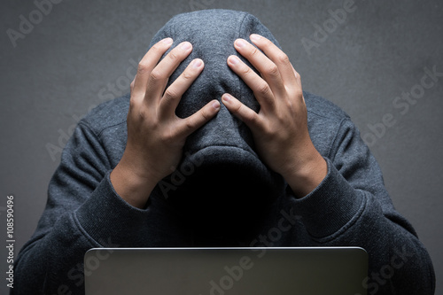 disappointed hacker with computer notebook