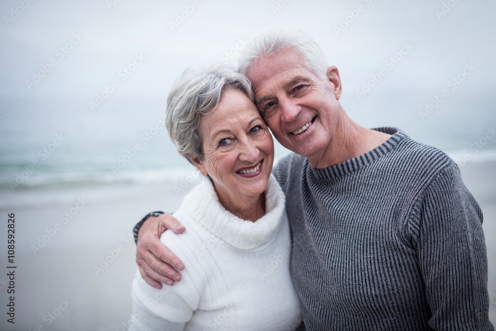 Happy senior couple embracing on the beach