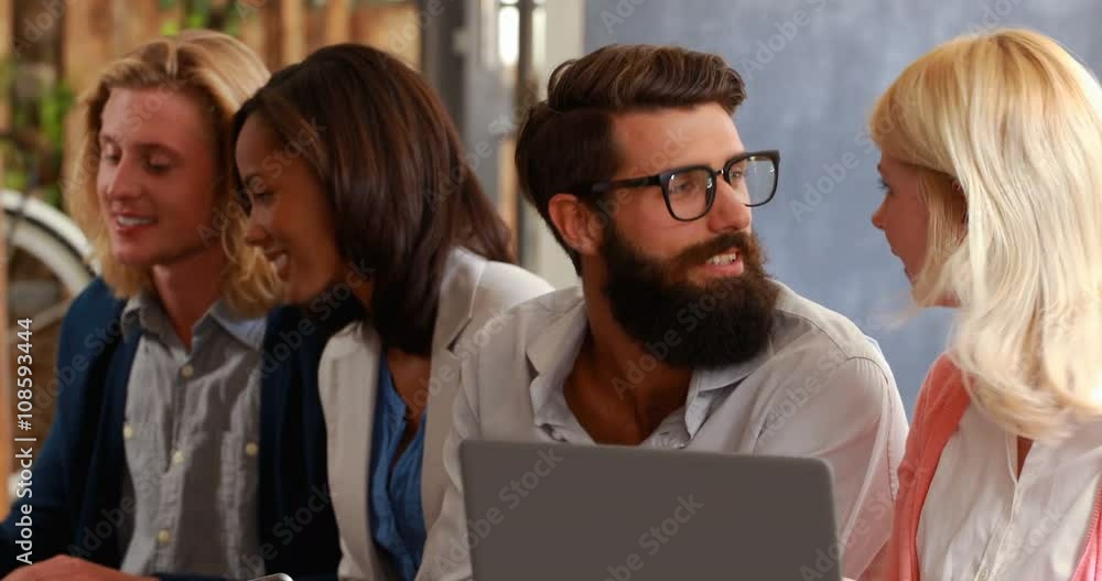 Hipster friends talking and using laptop Hipster friends talking and using laptop