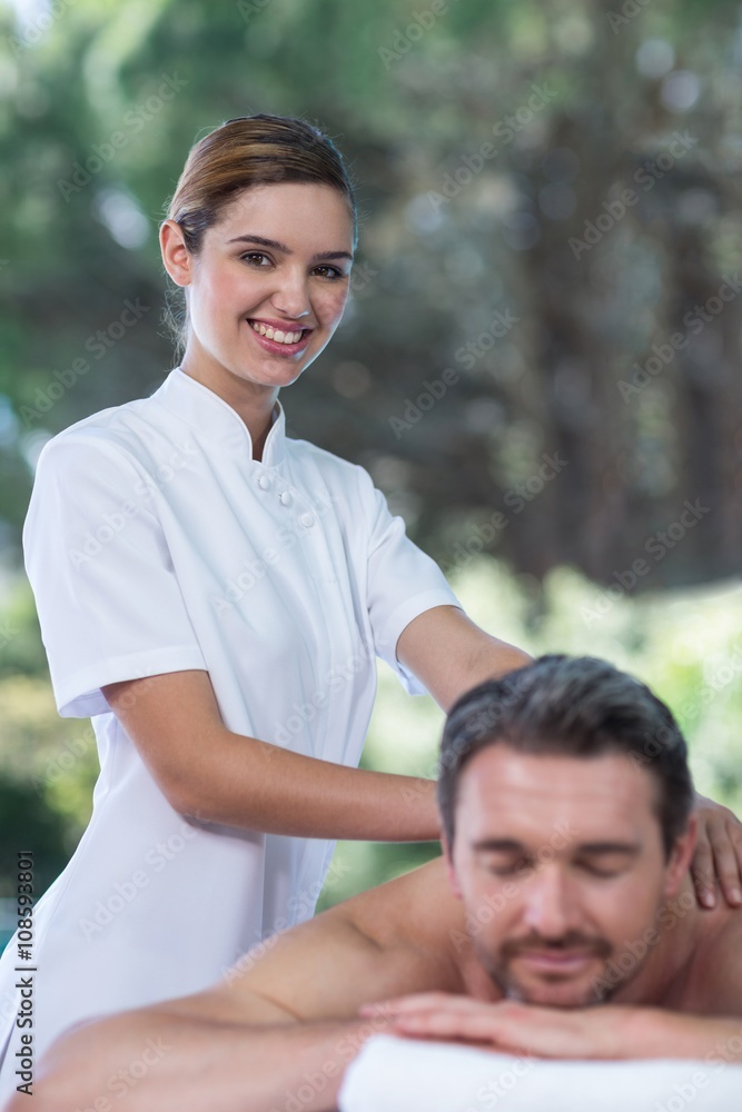 Obraz premium Man receiving back massage from masseur