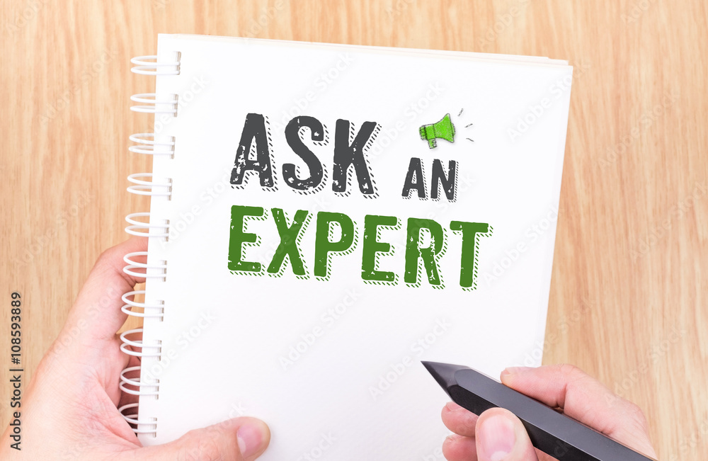 Ask an expert word on white ring binder notebook with hand holdi