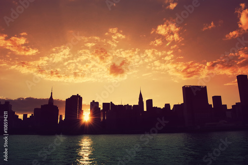 Manhattan, New York City skyline at sunset. View from Long Island City. Urban living, real estate, architecture, travel, career, night life and transportation concept