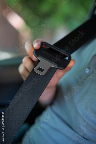 Driver holding car seat belt