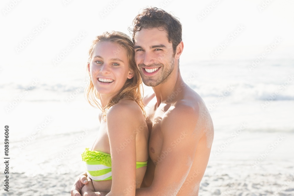 Happy couple embracing on the beach Happy couple embracing on the beach