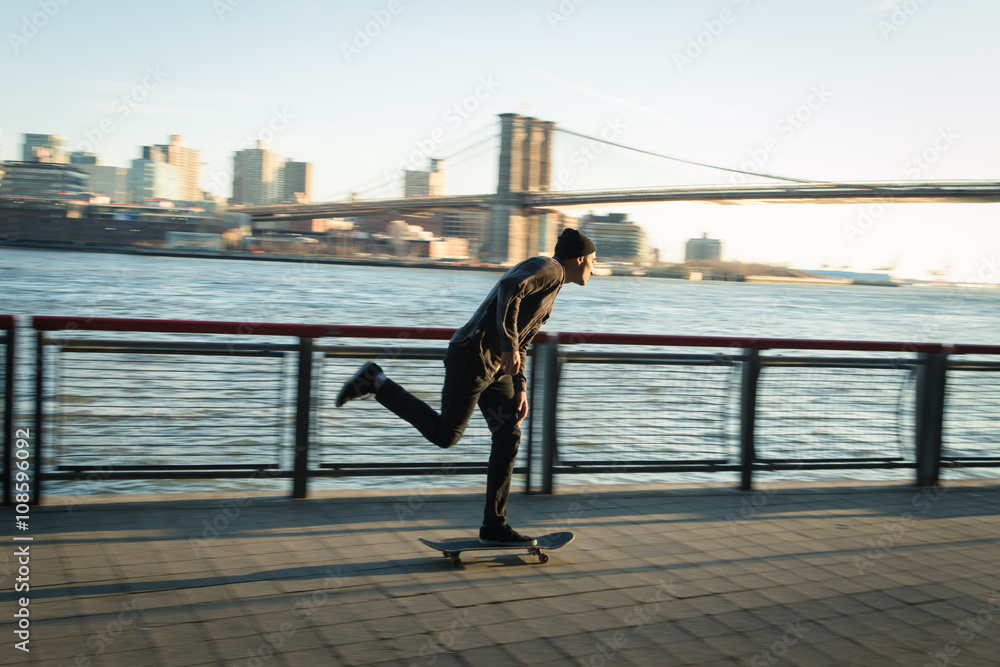 Young skateboarder cruise down on pedestrian walk
