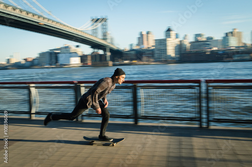 Young skateboarder cruise down on pedestrian walk photo