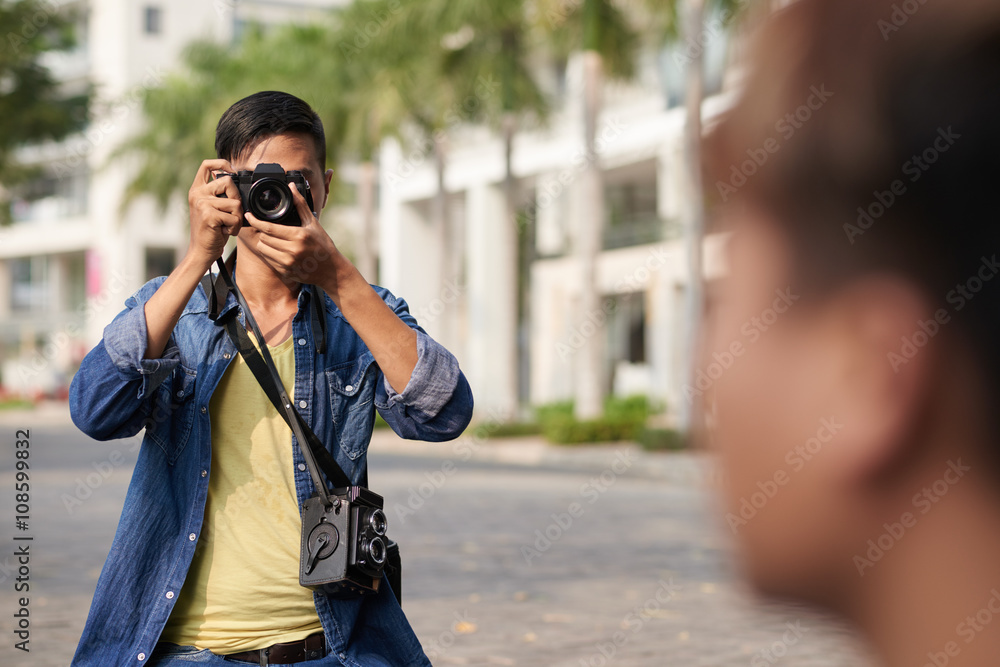 Photographer taking photo of model in the street