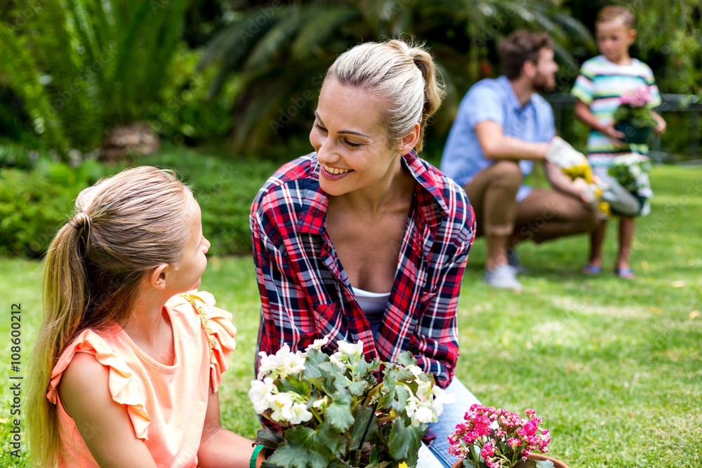 Smiling mother looking at daughter in yard Smiling mother looking at daughter in yard