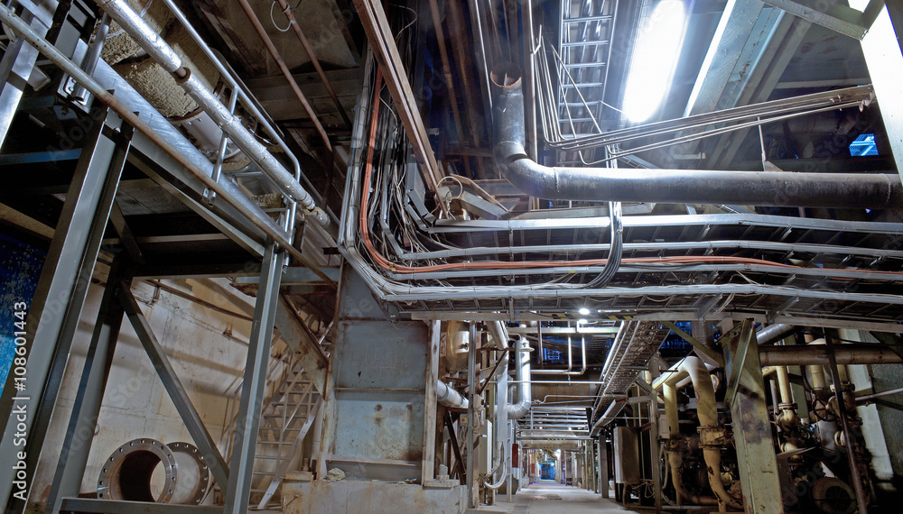 Fototapeta premium Equipment, cables and piping as found inside of a modern industr