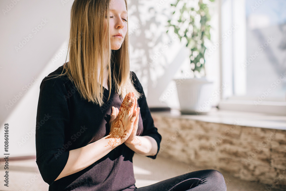 Fototapeta premium Young woman practicing meditation indoors