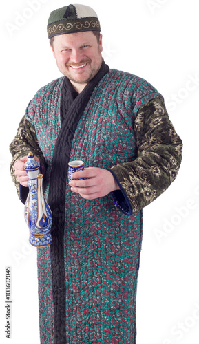 Man in traditional oriental robe with ornamental bow photo