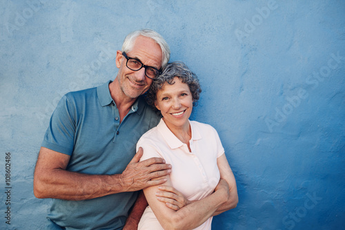 Smiling mature couple standing together photo