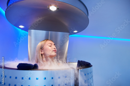 Young woman in a whole body cryo sauna photo