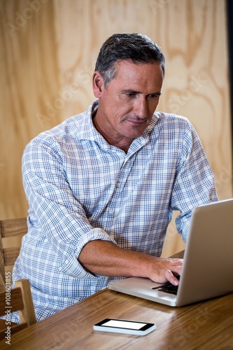 Man using laptop in office