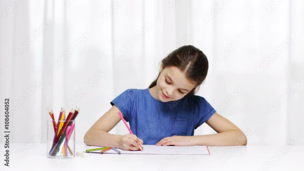 happy girl drawing with colour pencils at home happy girl drawing with colour pencils at home