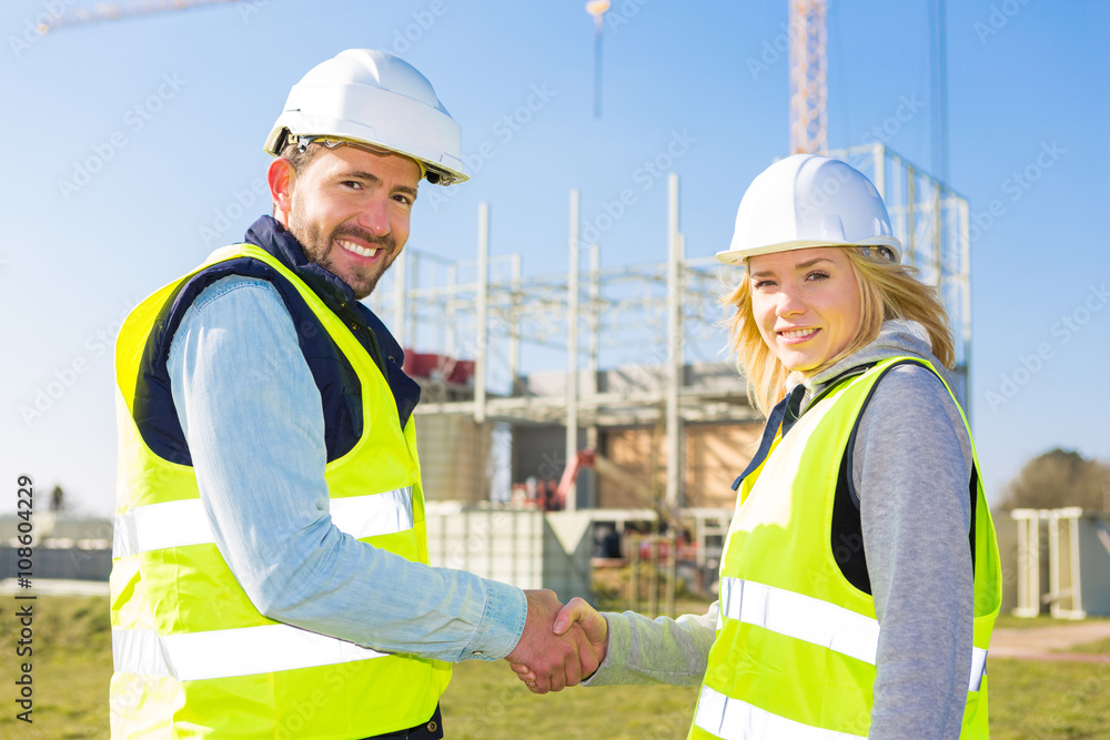 architect and worker handshaking on construction site architect and worker handshaking on construction site