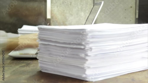 papers drop, working on laptop with papers time lapse