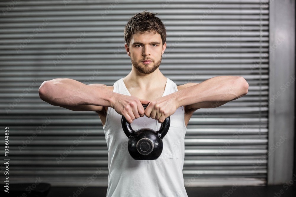 Obraz premium Fit man lifting a dumbbell