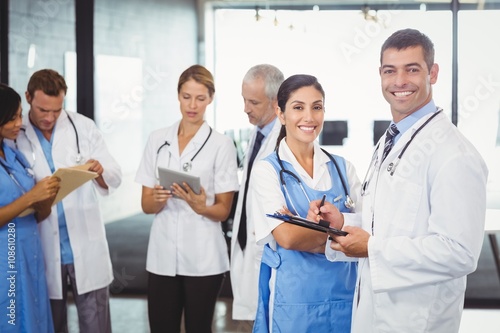 Doctors holding clipboard in hospital