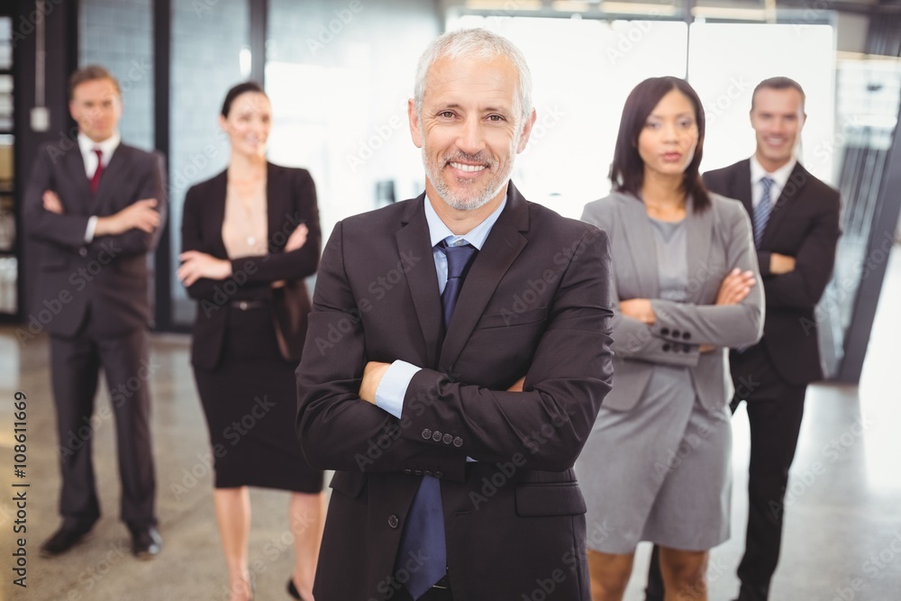 Businesspeople standing with arms crossed Businesspeople standing with arms crossed