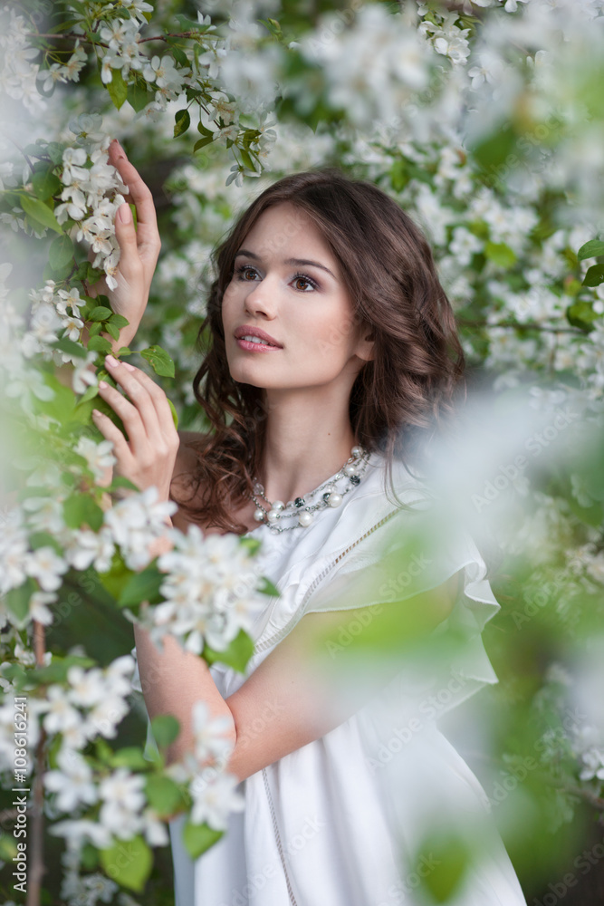 Fototapeta premium The young girl in a garden