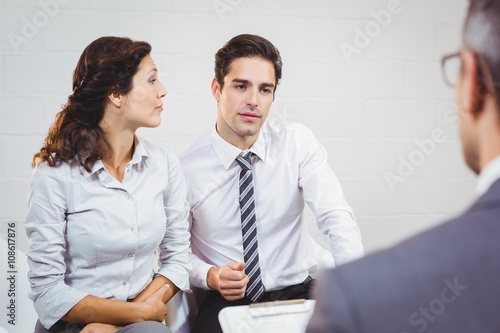 Clients discussing with businessman 