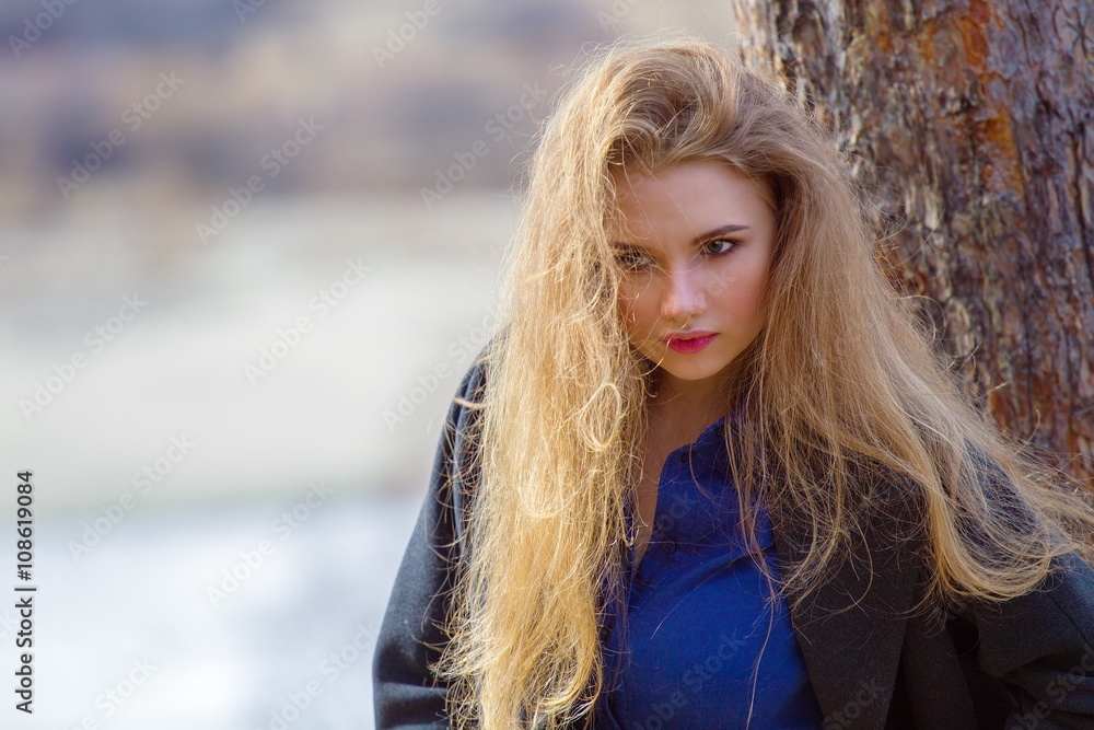 Beautiful girl in a coat in the woods on the mountain. Beautiful girl in a coat in the woods on the mountain.