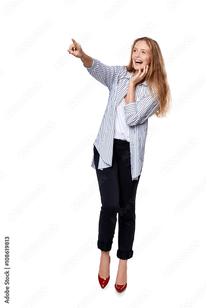 Happy excited woman in full length pointing to the side Happy excited woman in full length pointing to the side