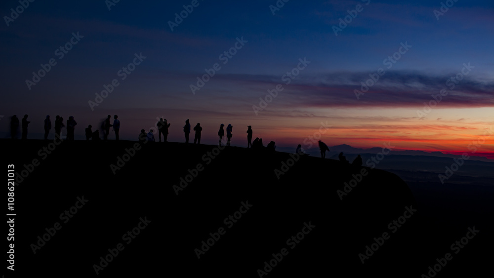 silhouette group of young people waiting sunrise