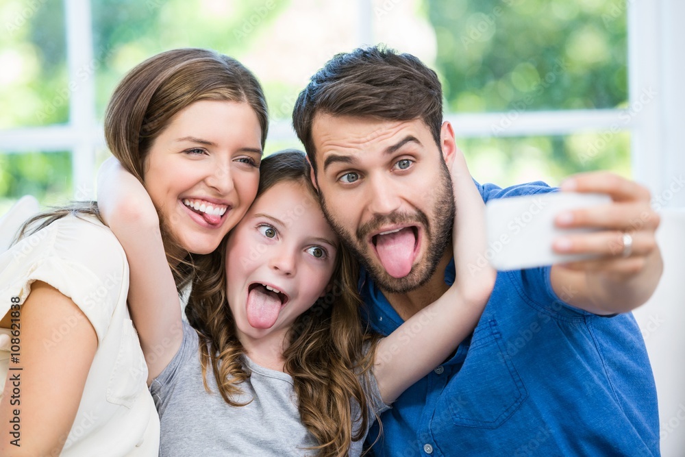 Happy family making faces while clicking selfie Happy family making faces while clicking selfie