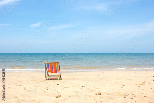 Fototapeta Naklejka Na Ścianę i Meble -  Deckchair, chair on the beach in sunshine day.