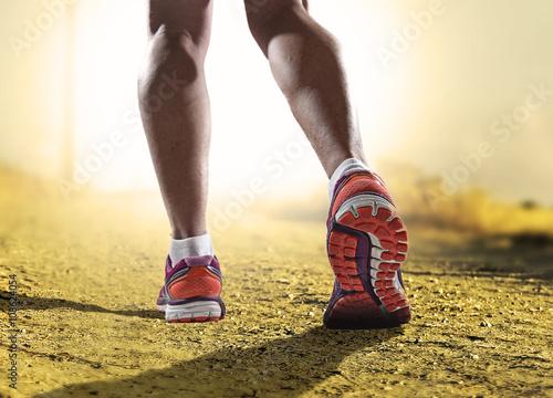 close up feet with running shoes and female strong athletic legs of sport woman jogging in fitness training