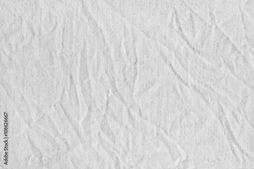White canvas with delicate striped pattern, crumpled. Fabric.