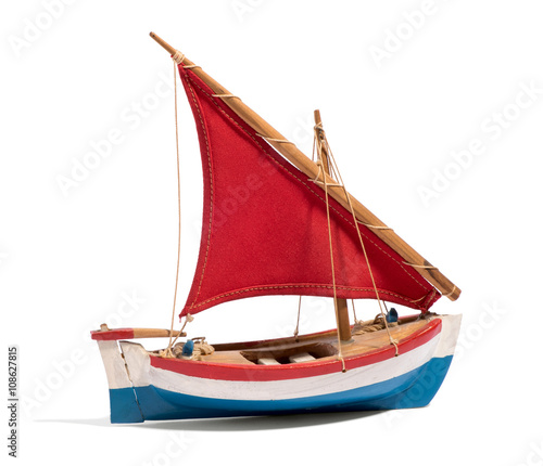 Canvas Print Wooden handmade toy boat with a red sail