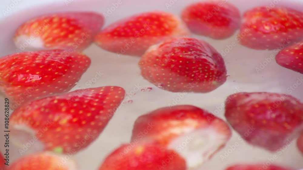 Fresh strawberries in water in slow motion Fresh strawberries in water in slow motion