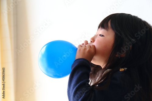 風船を膨らます子ども