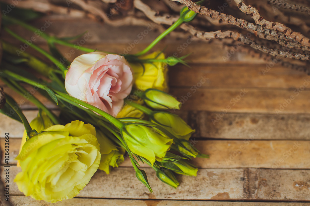 eustoma and rose  lying on a wooden board