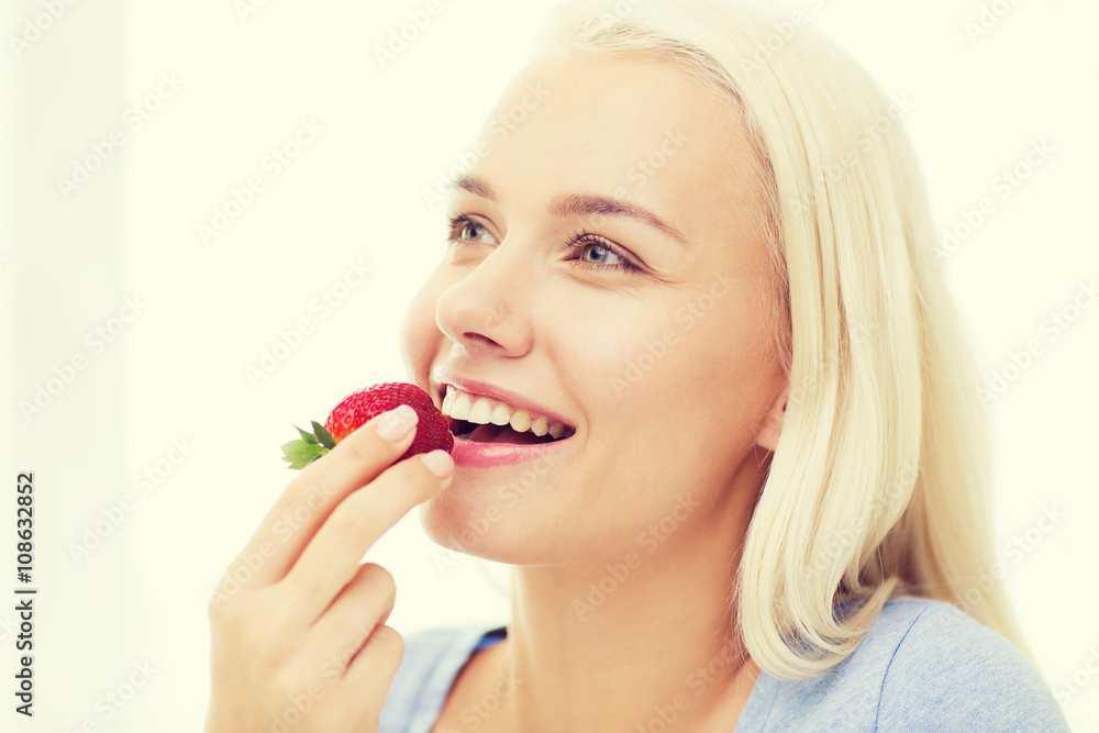 happy woman eating strawberry at home happy woman eating strawberry at home