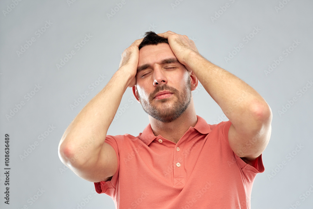 unhappy man suffering from head ache unhappy man suffering from head ache