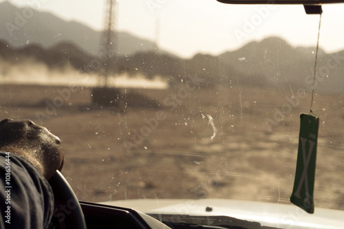 Desert hand on the steering wheel safari day
