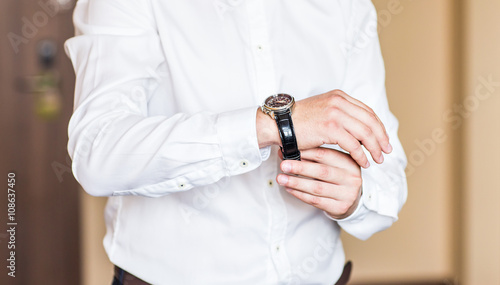 close-up of man puts on a watch