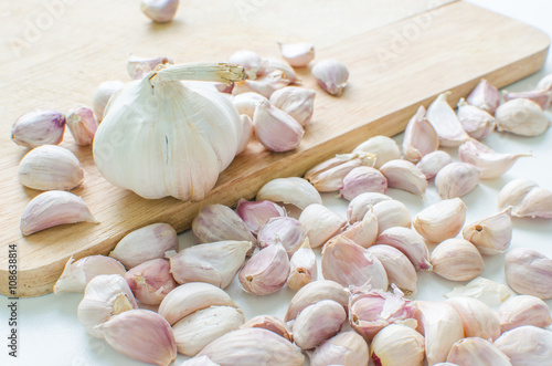 sliced garlic on wooden background
