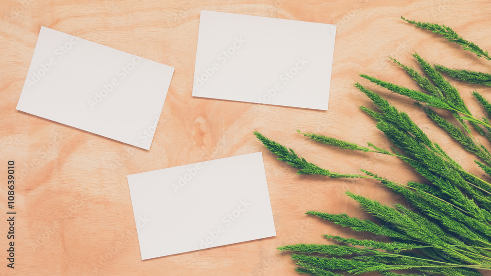 Top view of blank postcards with whet crop on wooden table background. Top view of blank postcards with whet crop on wooden table background.