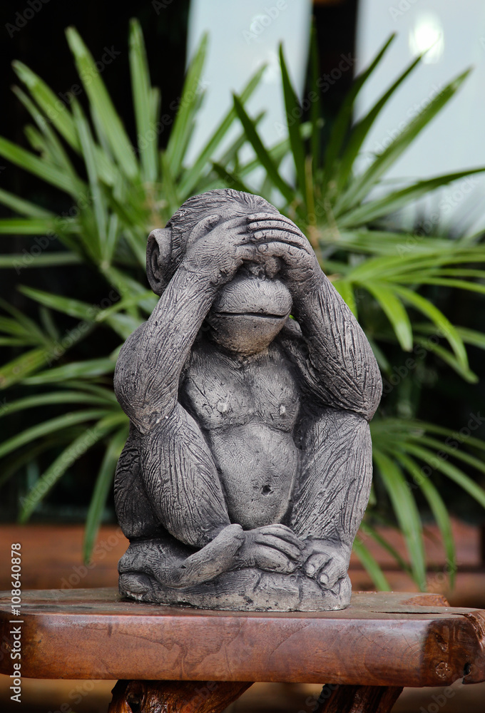 Fototapeta premium Monkey sculpture on wooden stick.