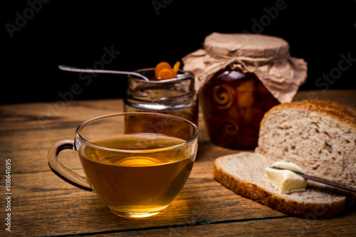 Homemade citrus orange jam on toast over wooden table