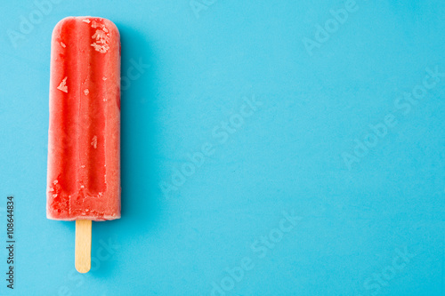 Strawberry popsicle on blue background
