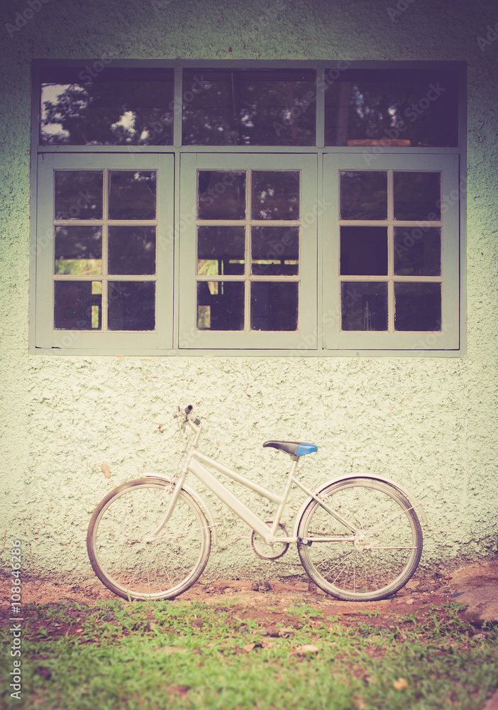 Vintage bike against wall,vintage tone style