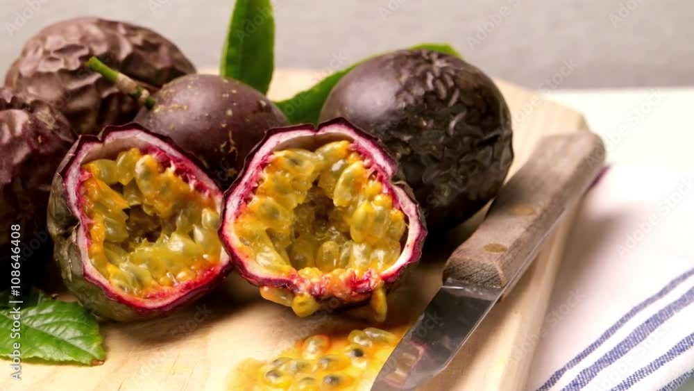Passion fruits on wooden tray on wooden table background. Passion fruits on wooden tray on wooden table background.