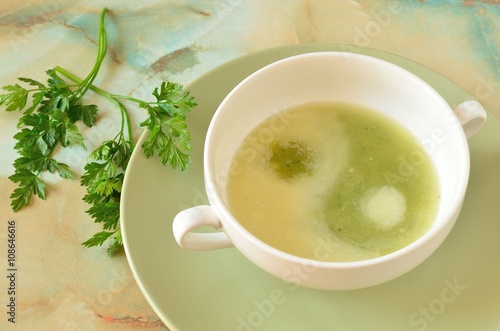 Рea and potato soup with cream in the shape of a Yin-Yang symbol in the bowl