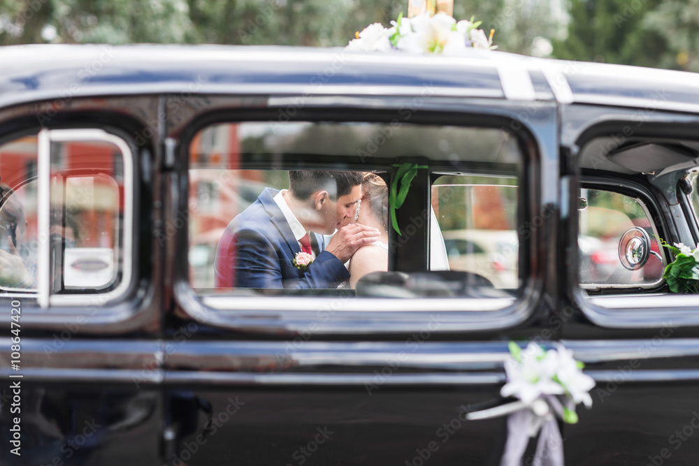Beautiful Romantic Bride with Groom Kissing and Embracing Outdoors Beautiful Romantic Bride with Groom Kissing and Embracing Outdoors
